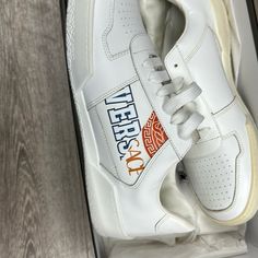 All White Classic Versace Designs On Sides Brand New. Bottom Of Sneakers Slightly Different In Color, Looks Cream On One End. White Sneakers With Logo And Round Toe, White Round Toe Sneakers With Logo, White High-top Sneakers With Branded Heel Counter, Designer White High-top Sneakers With Round Toe, Designer White High-top Sneakers With Logo, White Custom Lace-up Sneakers With Logo, Designer White Sneakers With Logo, White Custom Sneakers With Logo Print, Custom White Lace-up Sneakers With Logo