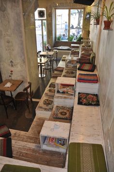 the interior of a restaurant with many tables and benches lined up against the wall next to each other