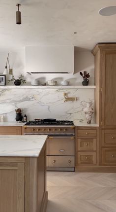 a kitchen with marble counter tops and wooden cabinets