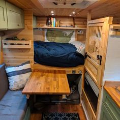 the interior of a small camper with wood flooring and walls that have been built into it