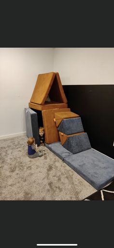 a room that has some kind of furniture on the floor and carpet in front of it