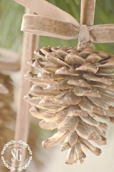 a pine cone ornament hanging from a tree