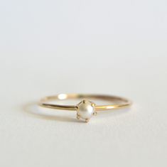 Stunning cultured freshwater pearl ring. Dainty 3mm pearl, this pearl is a beautiful cream white set in a prong setting. Polished for a beautiful shine finish.  *MATERIAL OPTIONS- -14k Solid (Yellow) Gold -14k Solid White Gold *Our 14k solid gold rings are gift wrapped in a beautiful ring box with satin bow. Made to order in your size. Sizes in drop down box are U.S. ring size.  I really want you to be happy with your purchase. If you have any questions or concerns please just let me know:) Classic Jewelry Ring With Pearl Charm, Classic Pearl Charm Ring For Wedding, Minimalist Pearl Rings With Pearl Charm, Delicate Yellow Gold Pearl Drop Ring, Pearl Drop Promise Ring, Yellow Gold Akoya Pearl Ring With Pearl Drop, Elegant 14k Gold Pearl Ring With Charm, Timeless Pearl White Rings With Pearl Drop, Akoya Pearl Drop Ring In Yellow Gold