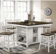 a kitchen table with chairs and a wine rack