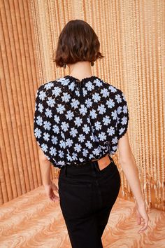 the back of a woman's top with flowers on it