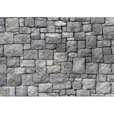 a stone wall that looks like it has been made out of rocks and is grey