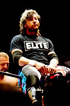 a man sitting on top of a wrestling ring