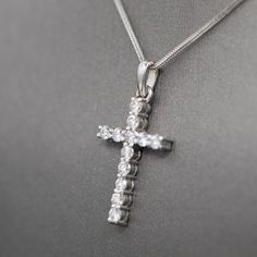 This sparkling cross is a beautiful way to wear your faith. Handcrafted in our Portland, Oregon studios, the cross features 12 2.7mm diamonds totaling 0.89cttw. The stones are F/G color and VS clarity- exceptionally nice stones. The cross measures 1 1/4" in length and is just under 5/8" across in width. It is crafted in solid 14k white gold and weighs 3.08. This listing is for the pendant only, chains can be purchased separately. Diamond White Diamond Cross Necklace, Cubic Zirconia Crucifix Necklace With Brilliant Cut, Diamond White Brilliant Cut Cross Necklace, Cubic Zirconia Brilliant Cut Crucifix Necklace, Brilliant Cut Cubic Zirconia Crucifix Necklace, Diamond Cross Necklace With Brilliant Cut, Christian Cross, The Cross, Portland Oregon