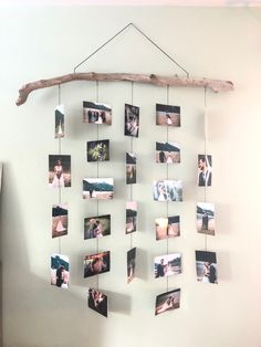 a wall hanging with multiple photos and a wooden stick on it's side in front of a white wall