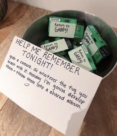 a bowl filled with lots of green batteries next to a sign that says help me remember tonight