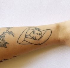 a woman's arm with tattoos on it