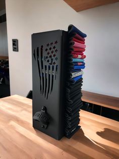 a stack of folded books sitting on top of a wooden table