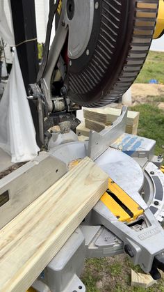 a person using a circular saw to cut wooden planks with a mitting machine