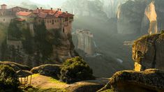 an old castle perched on the edge of a cliff