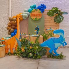 a dinosaur birthday party with balloons and decorations