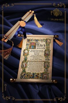 an old scroll with tassels on it and a diploma in front of blue fabric