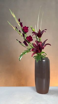 a vase filled with purple flowers on top of a table