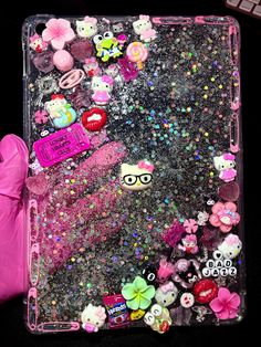 an ipad case is covered in glitter and other things that are all over the place