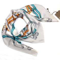 Gucci Scarves | Silk Square Scarves Gucci Original Gucci scarf, Gray / Turquoise / Brown equestrian belts design, twill silk square scarf, hand rolled borders, made in Italy. Gucci women collection scarves, shawls and wraps at outlet prices. Colors: Gray / Turquoise / Brown/ White Fabrics: 100% Twill Silk Size: 36" x 36" = 90cm x 90cm Genuine/ Authentic Origin: Made in Italy Brand: Gucci Product Code: gucc-sc210652 Belts Design, Gucci Scarves, Equestrian Belts, Equestrian Design, Designer Shawl, Gucci Scarf, Gucci Women, Silk Square Scarf, Italian Women