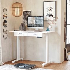 a white desk with a computer on top of it next to a window and rug