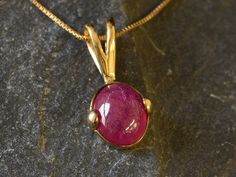 Gold Ruby Pendant set with a Natural Ruby in a natural red color & translucent clarity, at 10x8mm size (3 Cts) sourced from Burma.Gold Vermeil: 18k Gold over Solid 925 Sterling Silver ☞ made to last. Click here for ☞ Matching Ring Matching Earrings - please ask me Details:• Natural Ruby sourced from Burma• Ruby: 10x8mm, 3 Cts total, cabochon cut• Pendant Height 18mm, Width 10mm• Free Complimentary Chain• 18k Gold Vermeil❀ Each Natural Gem is unique & will have Slight variations from the product Elegant Red Cabochon Gemstones, Formal Oval Cabochon Ruby Jewelry, Formal Ruby Jewelry With Oval Cabochon, Oval Cabochon Ruby Jewelry For Formal Occasions, Ruby Cabochon Round Jewelry, Red Ruby Oval Cabochon Jewelry, Yellow Gold Ruby Oval Pendant Jewelry, Yellow Gold Ruby Oval Pendant, Oval Cabochon Ruby Gemstones