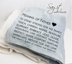 three folded towels are stacked on top of each other, with the words meanding of father printed on them