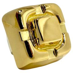 This vintage David Webb treasure is truly monumental in size and scale. The visceral impact that it makes is undeniable. Crafted as one solid piece of highly dimensional 18k yellow gold, it is very simple and at the same time it makes a strong statement. The design area measures a full 1 inch in diameter and rises 5/8 inches above the finger. Inside the ring is a white gold sizing spring stamped with WEBB, copyright, registration marks, and 18k. Ring is size 4 3/4. Gross weight 29.50 grams.