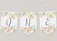 three banners with flowers and numbers hanging from them