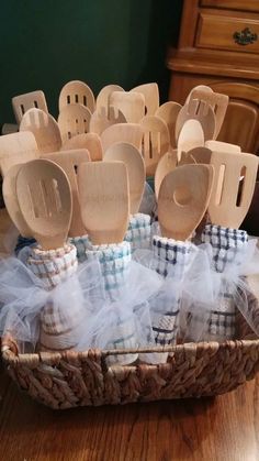 a basket filled with wooden spoons on top of a table