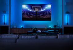 a living room with blue lighting and a basketball hoop on the wall