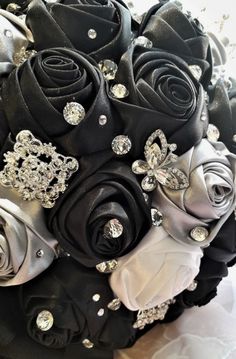 a bridal bouquet with black roses and crystal brooches