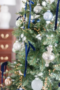 a decorated christmas tree with blue and white ornaments