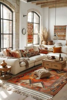 a living room filled with furniture and lots of windows