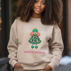 Merry Poodlemas!  A Poodle in a Christmas costume is irresistible! Apropos for everything, this holiday Poodle is available in both T-shirt & sweatshirts!   Ideal for any situation, a unisex heavy blend crewneck sweatshirt is pure comfort. These garments are made from polyester and cotton. This combination helps designs come out looking fresh and beautiful. The collar is ribbed knit, so it retains its shape even after washing. There are no itchy side seams on these sweaters.  .: Made with a medium-heavy fabric blend of 50% cotton and 50% polyester (8.0 oz/yd² (271.25 g/m this sweatshirt feels cozy and is the perfect choice for those colder months. .: The classic fit along with the crew neckline deliver a comfy wearing experience with a clean-cut style. Meanwhile, the double-needle stitchin Poodle Costume, Christmas Poodle, Pugs In Costume, Pug Gifts, Funny Dog Shirts, Christmas Costume, T Shirt Costumes, Christmas Costumes, Sweatshirt Christmas