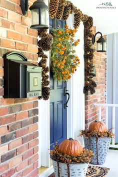 two buckets filled with pine cones sitting on the front porch