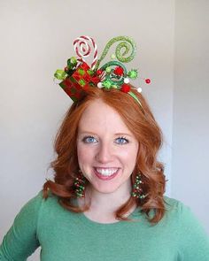 a woman with red hair wearing a christmas hat