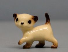 a small figurine of a dog on its hind legs