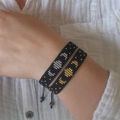 a person wearing two bracelets on their arm