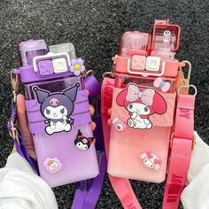 two cell phones with hello kitty cases on them