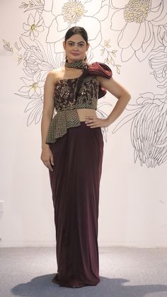 Its a stunning floor-length outfit made from Lycra fabric in an elegant Burgundy color. It features One Side Shoulder. It is embellished with intricate work including Cutdana, Sequins, and Stonework, making it a beautiful choice for special occasions and events. Complete the look by wearing Stone jewelry and bracelet. There might be little color variations in the image and original product due to photographic lightings or your monitor settings. Style: Gown Fabric: Lycra, Net Work: Stonework, Seq Gown For Party Wear, Lycra Gown, Gown For Party, Burgundy Gown, Indo Western Gown, Saree Petticoat, Evening Wrap, Full Sleeve Blouse, Saree Jewellery