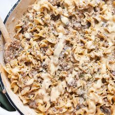 a casserole dish with meat, cheese and sauce in it on a table