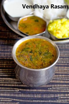 vendaya rasam served in small metal dishes with rice and vegetables on the side