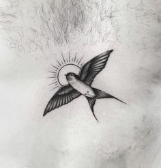 a black and white photo of a bird flying with the sun in its back tattoo