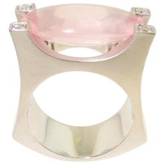 Stunning solitaire Cocktail ring featuring a 8.48 Carat oval Buff-Top Rose Quartz measuring approx. 20mm x 10mm; each corner enhanced with a round Diamond; 4 round Diamonds approx. 0.10 total carat weight; Sterling Silver Tarnish-resistant Rhodium Satin finish mounting; Size 8; we offer complimentary ring re-sizing. Classic and Chic…taking you from day to evening with style and grace! Rose Cocktail, White Gold Diamond Earrings, Elegante Y Chic, Platinum Diamond Rings, Gold Cocktail Ring, Pendant Watches, Rose Quartz Ring, Diamond Quartz, Gold Diamond Earrings