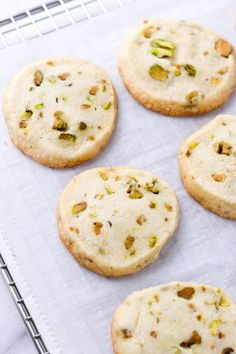 several cookies with pistachios are on a cooling rack