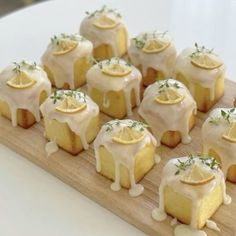 small lemon cakes with white icing on a wooden board