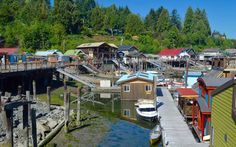 boats are docked in the water near houses