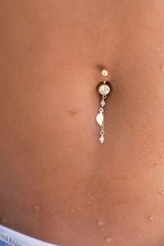 "A beautiful belly button ring to complete your look every day! The barbell is made of surgical steel. A tiny leaf pendant made of 14k gold filled and 2 pink Swarovski crystal beads are dangling from the bottom barbell with a dainty gold filled chain, to create a delicate piece of body jewelry. Do not hesitate to contact me for special requests and customization! ♥♥ ▶ Surgical steel curved barbell, 11 mm long (not including the barbells) for a universal fit. ▶ 14K goldfilled leaf charm (approx. Percinings Ideas Belly, Elegant Belly Button Piercing, Belly Button Piercing Pain Chart, Belly Piercing Ideas, Belly Button Piercing Dangle, Belly Pierce, Dainty Belly Button Piercing, Belly Button Piercing Gold, Cute Belly Button Piercing