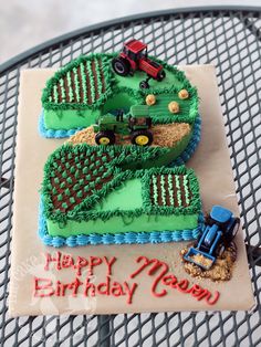 the birthday cake is shaped like a farm tractor and number two on it's side