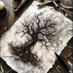 a piece of paper with a drawing of a tree on it next to some scissors